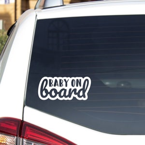 May include: White vinyl car sticker with the text "BABY ON board" in a cursive font.