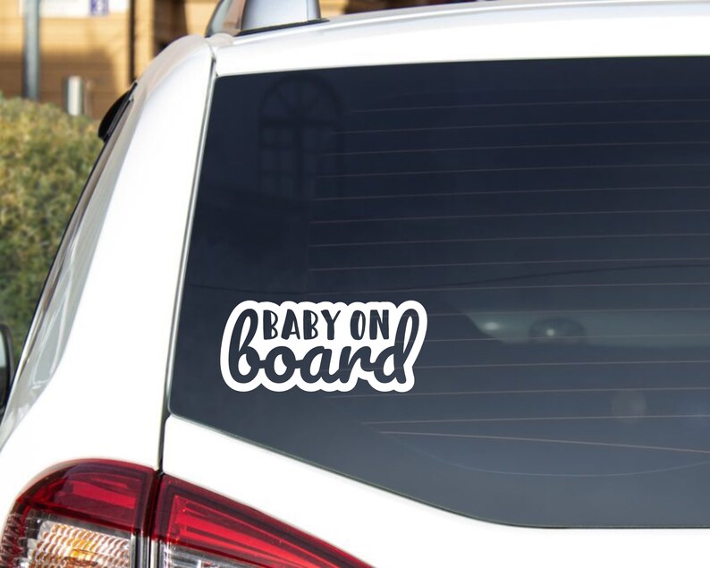 May include: White vinyl car sticker with the text "BABY ON board" in a cursive font.
