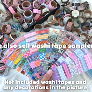May include: An assortment of washi tapes in various colors and patterns, including floral, geometric, and solid designs. The image also shows washi tape samplers. Text on the image reads: "We also sell washi tape samplers!" and "Not included washi tapes and any decorations in the picture."