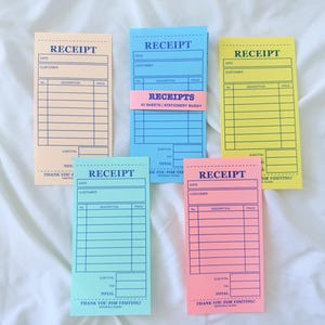 May include: Five rectangular receipt pads in peach, blue, yellow, teal, and pink paper. Each pad features dark blue printed lines, the word RECEIPT at the top, fields for date and customer, a table for description and price, and THANK YOU FOR VISITING.
