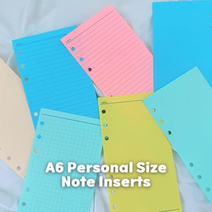 May include: A collection of A6 personal size note inserts in various colors including blue, pink, yellow, and cream. The paper sheets feature different layouts such as lined, grid, and blank, each with pre-punched holes along the side for binder use.