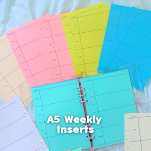 May include: A collection of A5 weekly planner inserts in various pastel colors including pink, yellow, blue, purple, and cream. The pages feature a grid layout with printed days of the week and the text A5 Weekly Inserts centered on the page.