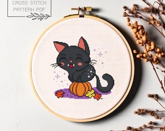 May include: Cross stitch pattern PDF of a black cat sitting on a pumpkin with a purple background and stars. The cat has a mischievous grin and is wearing a star on its chest.