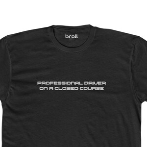May include: Black t-shirt with the text "PROFESSIONAL DRIVER ON A CLOSED COURSE" in white.
