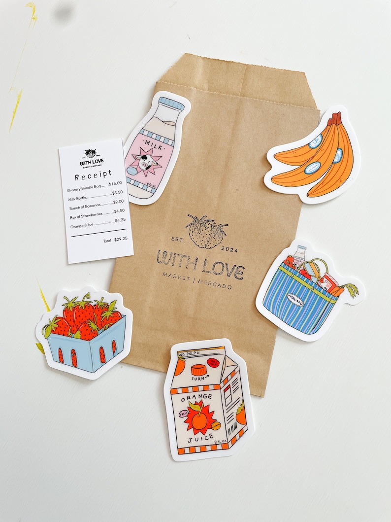 May include: A brown paper bag with various stickers on it. The stickers are of a milk carton with a cow on it, a bunch of bananas, a basket of strawberries, a carton of orange juice, and a grocery bag with groceries inside. The bag has the text "WITH LOVE MARKET | MERCADO" and "EST. 2024" on it.