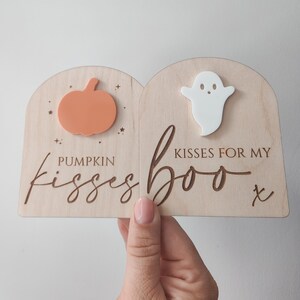 May include: Wooden sign with a pumpkin and ghost cutout. The sign reads "Pumpkin Kisses Boo Kisses for my Boo x".