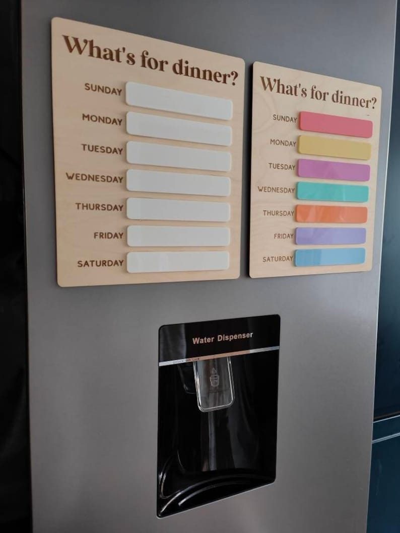 May include: Two wooden signs with the text "What's for dinner?" and blank spaces for each day of the week. The signs are hung on a stainless steel refrigerator with a water dispenser.