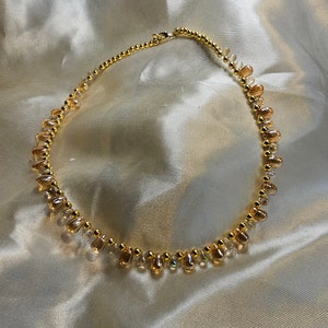 Bridgerton Collection Irridecent Peaches and Cream with Gold Necklace.