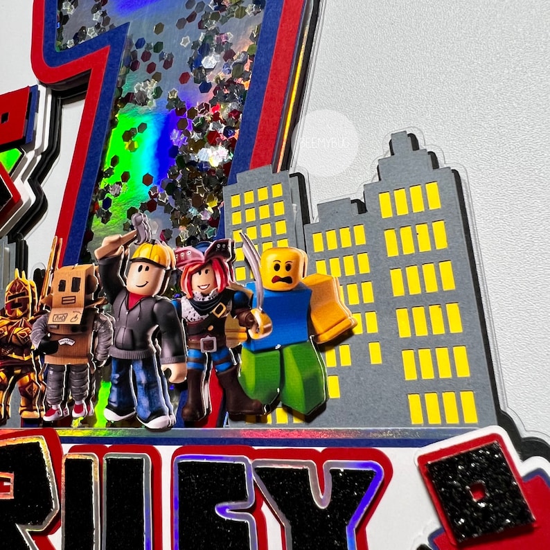 May include: A red, white, and blue glitter-filled number seven cake topper with a cityscape backdrop. The cityscape is made of gray cardboard with yellow windows. Four Roblox characters stand in front of the cityscape. The characters are wearing different outfits and holding various accessories. The cake topper says "Riley" in black letters.