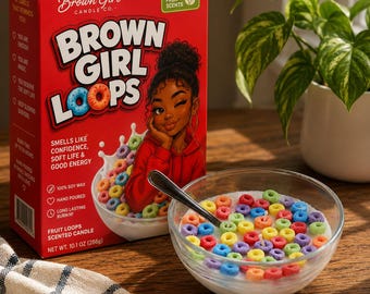 May include: A red box of "Brown Girl Loops" fruit loops scented candle, with a bowl of colorful cereal-shaped wax and a clear glass bowl with a spoon. The box features a winking illustration of a woman and the text "Smells like confidence, soft life & good energy."
