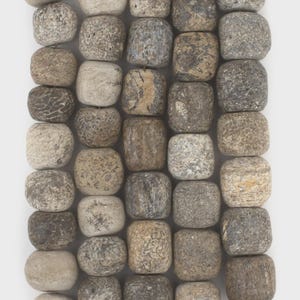 May include: A collection of five vertical strands of square-shaped beads with rounded edges. Each bead features a unique, natural stone-like texture with a color palette ranging from light beige and tan to dark gray, brown, and charcoal tones.