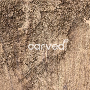 May include: A close-up of a 3D carved wooden map of a mountainous region. The map is detailed and shows the contours of the mountains. The wood is a light brown color and has a natural grain.