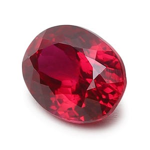 May include: A deep red oval-shaped gemstone with a faceted cut.