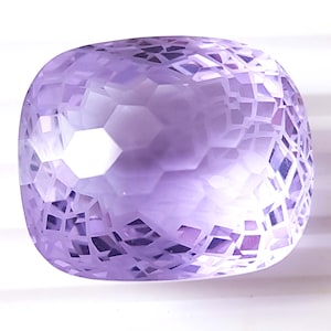 May include: A large, faceted, lavender amethyst gemstone with a cushion cut. The gemstone has a hexagonal pattern.