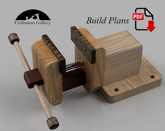 May include: A wooden bench vise with a wooden handle. The vise is made of light wood with dark wood accents. The vise is mounted on a wooden base. Build Plans PDF.