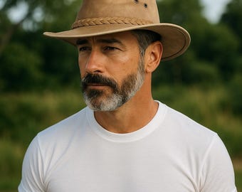 May include: A tan-colored, wide-brimmed hat with a braided band and three small eyelets. The hat is made of a soft material and has a slightly distressed appearance. The hat's brim measures approximately 3 inches.
