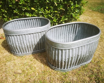 Pair Of Oval Ribbed Metal Planters