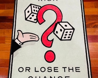 May include: A green and white rug with a black border. The rug features a red question mark, two dice, and the text "Take the risk or lose the chance".
