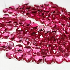 Puede incluir: Una hebra de cuentas de piedras preciosas facetadas de color rosa. Las cuentas son de forma ovalada y tienen un alto pulido.