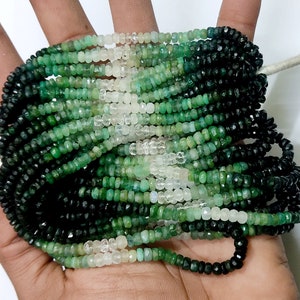 May include: Strands of faceted gemstone beads in shades of green and clear. The beads are small and uniform in size, creating a textured surface. The beads are strung together, forming a necklace or bracelet.