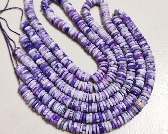 May include: Strands of purple and white disc-shaped beads. The beads are arranged in a layered pattern, showcasing a marbled effect. The beads are strung together with dark purple string, creating a necklace or bracelet.