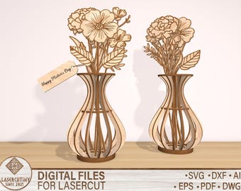 May include: Two laser cut wooden vases with floral designs. The vases are empty and have a delicate, intricate design. The text "Happy Mother's Day" is on a tag attached to one of the vases.