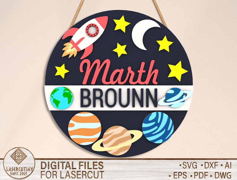 May include: A round, black and blue sign with a rocket ship, stars, a crescent moon, and planets. The sign says "Marth Brounn" in red and white letters.