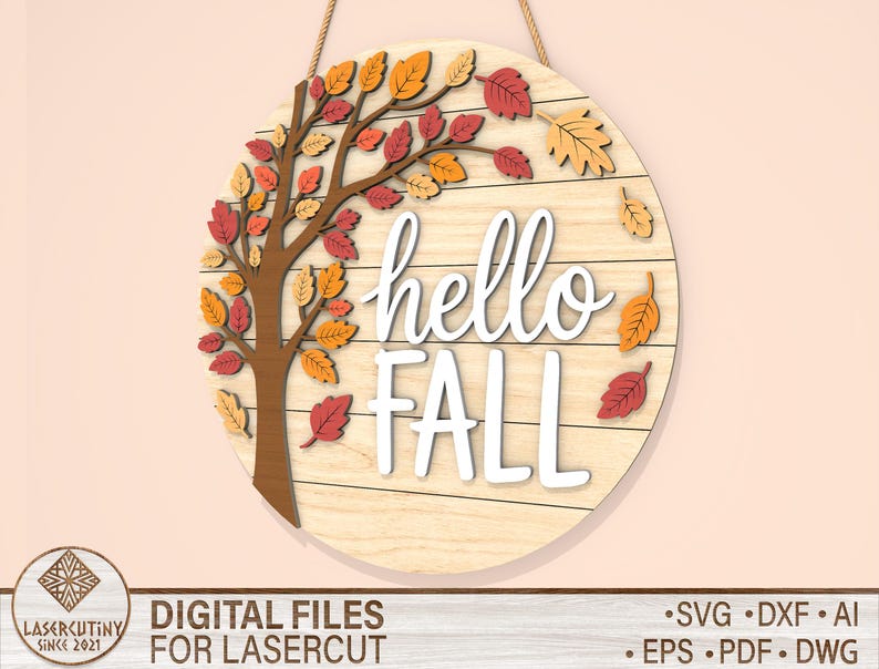 May include: A round wooden sign with the words "hello FALL" in white script. The sign features a tree with colorful fall leaves in shades of red, orange, and yellow. A rope is attached for hanging.