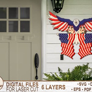 May include: A laser cut design of an American bald eagle holding two American flags. The design is made up of six layers and is available in SVG, DXF, AI, EPS, PDF, and DWG formats.
