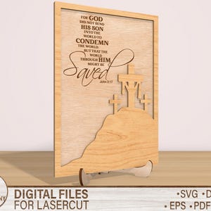 May include: A wooden sign with a laser-cut design of three crosses and the text "For God did not send his son into the world to condemn the world: but that the world through him might be saved. John 3:17".