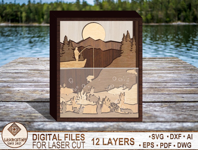 May include: A 12-layer laser cut wooden art piece depicting a fisherman casting a line in a lake with a mountain and sun in the background. The bottom layer shows fish and underwater plants.
