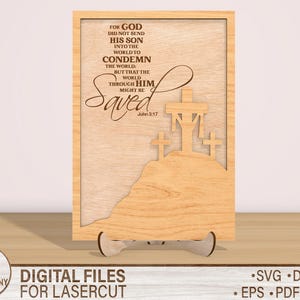 May include: A wooden sign with a laser cut design of three crosses and the text "For God did not send his son into the world to condemn the world: but that the world through him might be Saved. John 3:17".