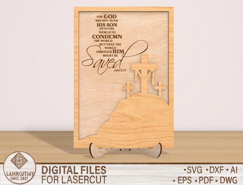 May include: A wooden sign with a laser cut design of three crosses and the text "For God did not send his son into the world to condemn the world: but that the world through him might be Saved. John 3:17".