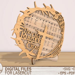 May include: A wooden cutout of a cross with a crown of thorns and music notes. The text "The Old Rugged Cross" is written on the cutout.