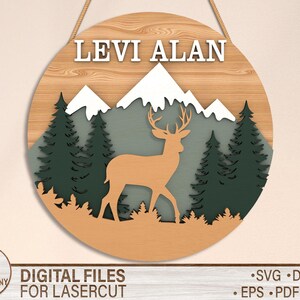 May include: A wooden sign with the name "LEVI ALAN" in white letters. The sign features a silhouette of a deer in a forest setting with mountains and trees.