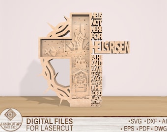 May include: A wooden cross with a crown of thorns design. The cross is decorated with a scene of the empty tomb and the text "He is not here for He is risen. He said I go to prepare a place for you. Where I am there you may be also. The Lord is risen. Matthew 28:6".