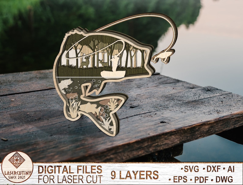 May include: A laser cut wooden design of a bass fish with a fisherman in a boat inside the fish. The design is layered and has a rustic wood finish. The text "DIGITAL FILES FOR LASER CUT 9 LAYERS" is at the bottom of the image.