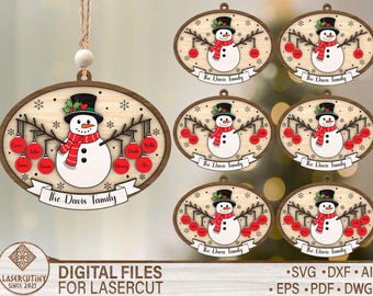 May include: Wooden Christmas ornaments featuring a snowman with a black top hat and red scarf. The snowman is surrounded by red ornaments with family names. The text "The Davis Family" is displayed on a banner. The ornaments are designed for laser cutting.