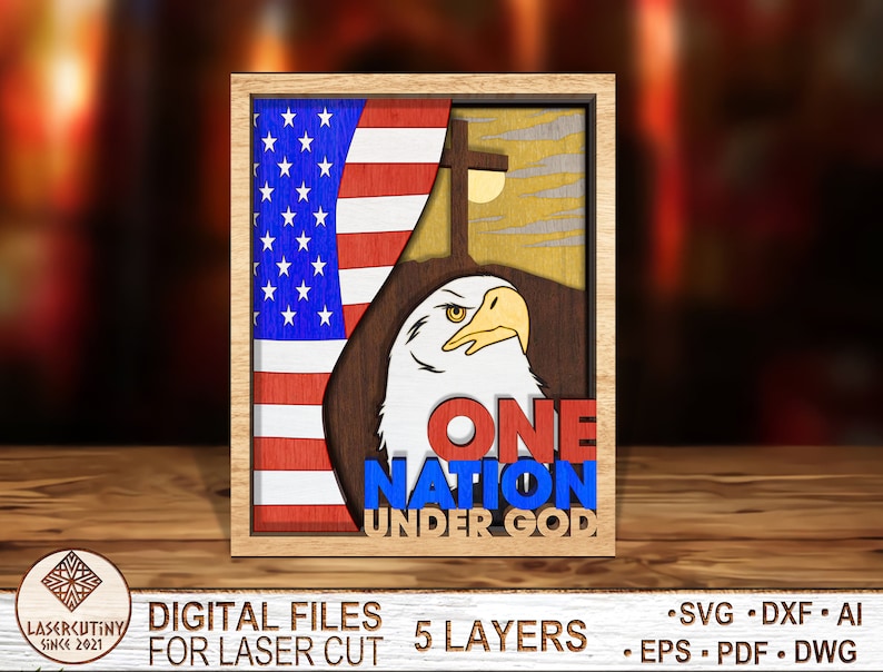 May include: A wooden cutout of an American bald eagle with the words "One Nation Under God" in red, white, and blue. The eagle is standing in front of a wooden cutout of the American flag.