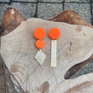 Mismatched geometric earrings of neon orange polymer clay and textured brass stripe and rhombus, birthday gift for her
