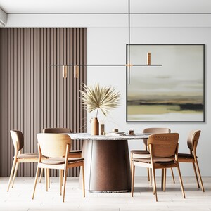 May include: A modern dining room with a round wooden table and six chairs. The table has a brown marble top and a brown leather base. The chairs are made of light wood with brown cushions. A black linear light fixture hangs above the table. A framed abstract painting hangs on the wall behind the table. A vase with dried palm leaves sits on the table.