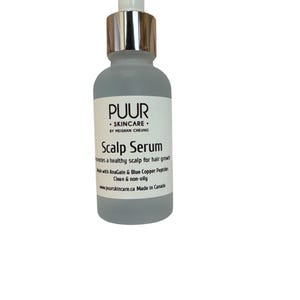 May include: A frosted glass bottle of PUUR Scalp Serum with a silver dropper. The label reads "Scalp Serum" and promotes healthy scalp and hair growth. The product is made in Canada.