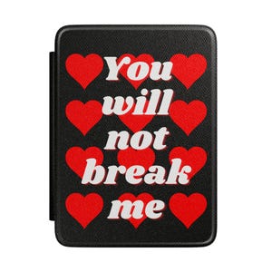 May include: A black rectangular e-reader case with a textured surface featuring a repeating pattern of red hearts. The white text "You will not break me" is printed in the center, arranged in four lines across the heart-patterned background.