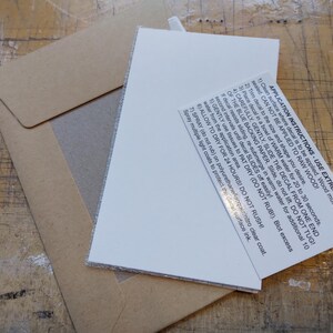May include: Close-up of a white card with black text outlining application instructions for a decal. The text reads: "APPLICATION INSTRUCTIONS USE EXTREME CARE 1) Clean surface where decal is to be applied. Wood must be sealed CAN NOT BE APPLIED TO RAW WOOD! 2) Trim decal to the size and shape you desire. 3) Place decal in a bowl of WARM water for 20 to 30 seconds. 4) CAREFULLY, GENTLY, SLIDE THE DECAL FROM ONE END OF THE BLUE BACKING PAPER. Slide, do not liDO NOT TUG! If decal resists sliding, re-submerge in warm water for additional 10 second intervals until decal SLIDES off easily! 5) GENTLY use tissues to PAT DRY (DO NOT RUBI). Blot excess water from the application area. 6) ALLOW TO DRY FOR 24 HOURS! DO NOT RUSH! 7) SPRAY (do not rub) on polyurethane lacquer/nitro clear coat. Spray multiple light coats to protect the decal surface ink."