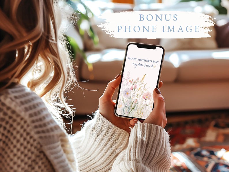 May include: A smartphone displays a floral Mother's Day greeting, held by a person wearing a cream-colored sweater. The phone's screen features pastel flowers and the text "Happy Mother's Day my dear friend". The image includes the text "BONUS PHONE IMAGE".