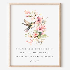 May include: A watercolor print with a hummingbird perched on a pink flower. The print features the quote "FOR THE LORD GIVES WISDOM: FROM HIS MOUTH COME KNOWLEDGE AND UNDERSTANDING. Proverbs 26"
