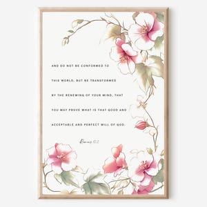May include: A printable wall art design featuring a floral illustration with pink flowers and green leaves. The design includes a quote from Romans 12:2, "And do not be conformed to this world, but be transformed by the renewing of your mind, that you may prove what is that good and acceptable and perfect will of God."