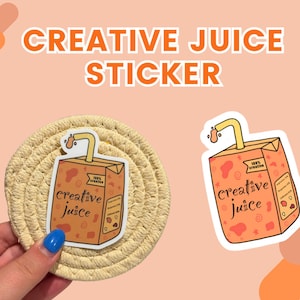 May include: A sticker of a cartoon juice box with a straw. The juice box is orange and has the words "Creative Juice" on it. The sticker is on a woven coaster.