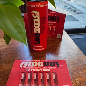 May include: Red and black energy drink can with the words "Ride Out" and "Ruff Ryders" on it. The can is sitting on a red and white flyer that says "Ride Out Energy Drink" and "Restore x Revitalize x Ride Out".