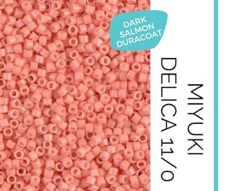 May include: A close-up of a pile of small, round, light pink beads. The beads are labeled "MIYUKI DELICA 11/0 DARK SALMON DURACOAT" and "WAYFINDER BEAD SUPPLY".